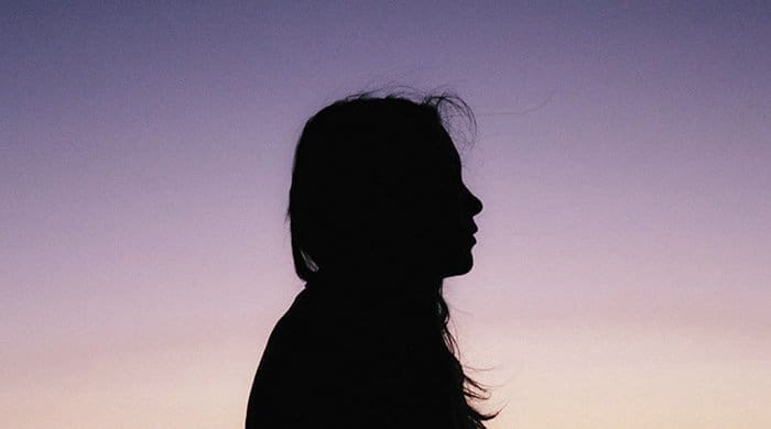 A profile shot of a woman to represent