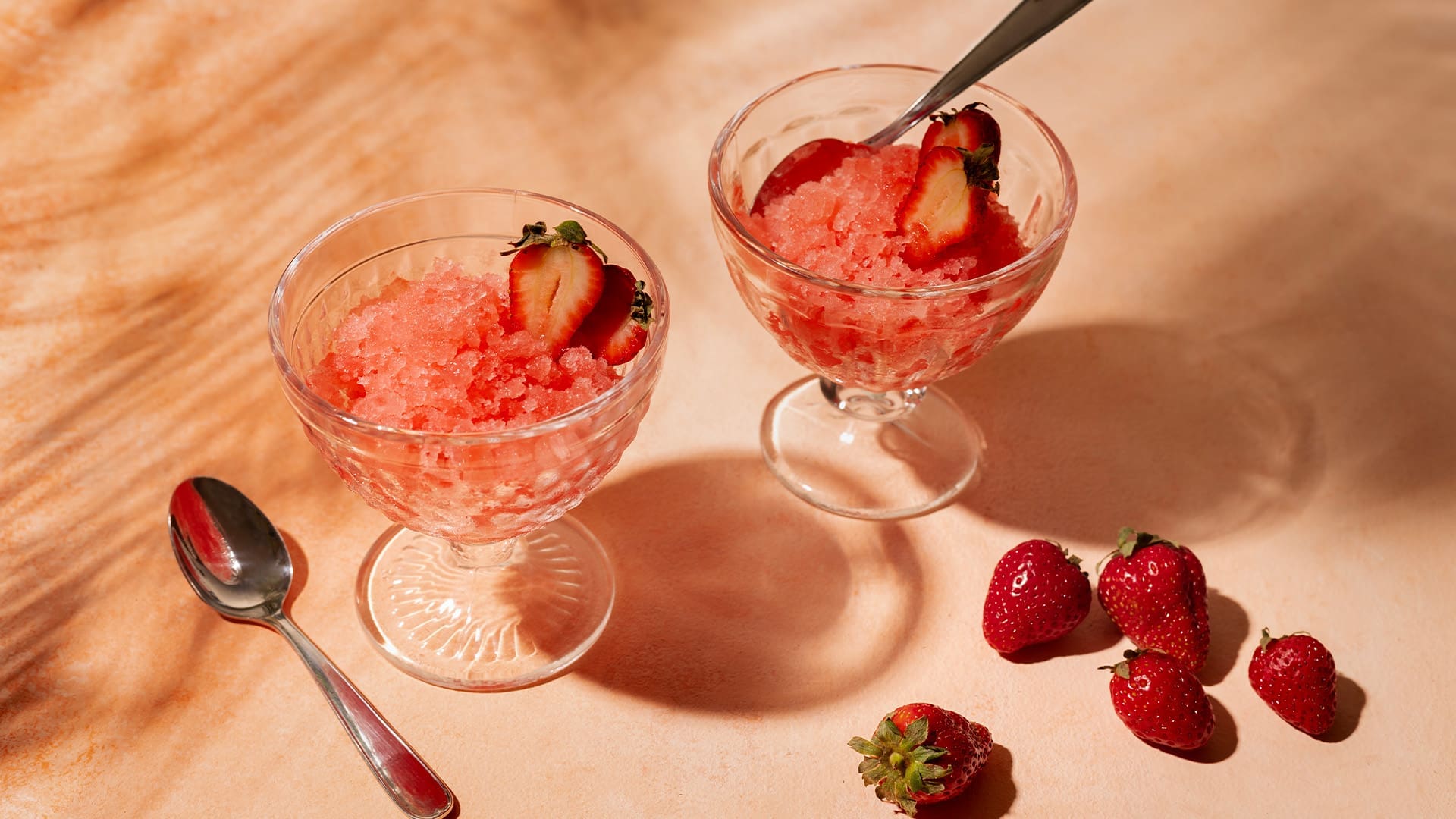 Strawberry sorbet in glasses with fresh strawberries on the side