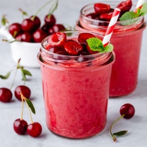 cherry smoothies fro weight loss on a background surrounded by cherries
