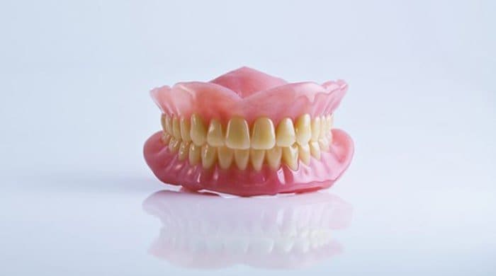 A fake jaw to illustrate jaw surgery and a liquid diet post-recovery