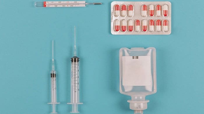 Medical equipment on a blue background that you would use to treat cervical cancer