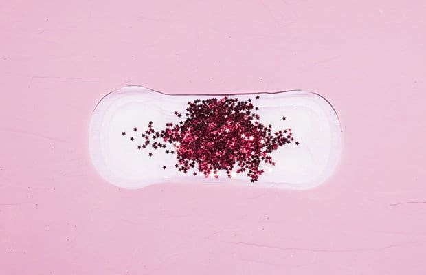 a pad with red glitter to represent a story about why you get horny on your period
