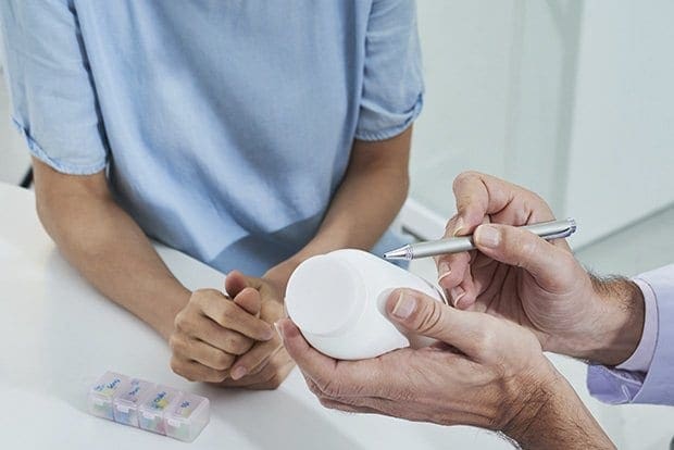 Low sex drive — sexual health doctor prescribing tablets or vitamins to patient