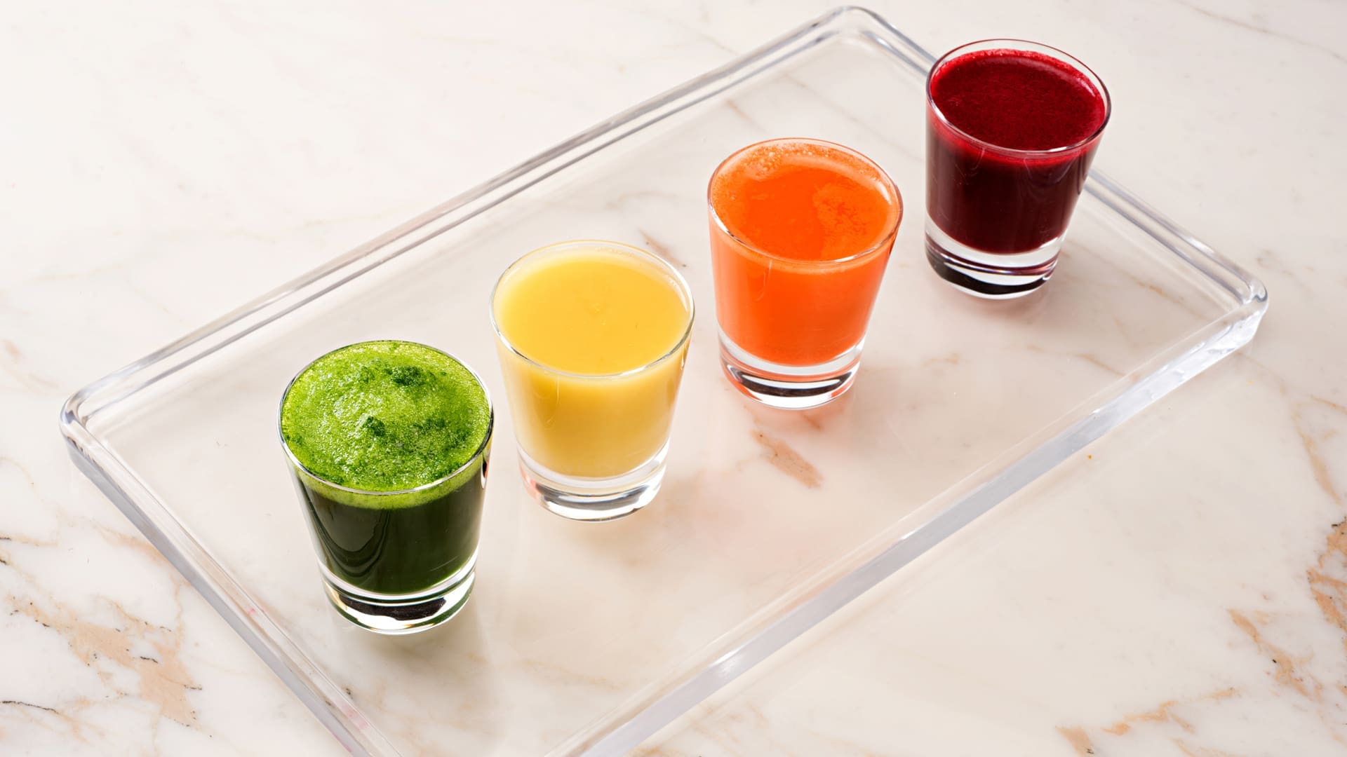 wellness shots lined up on a glass platter