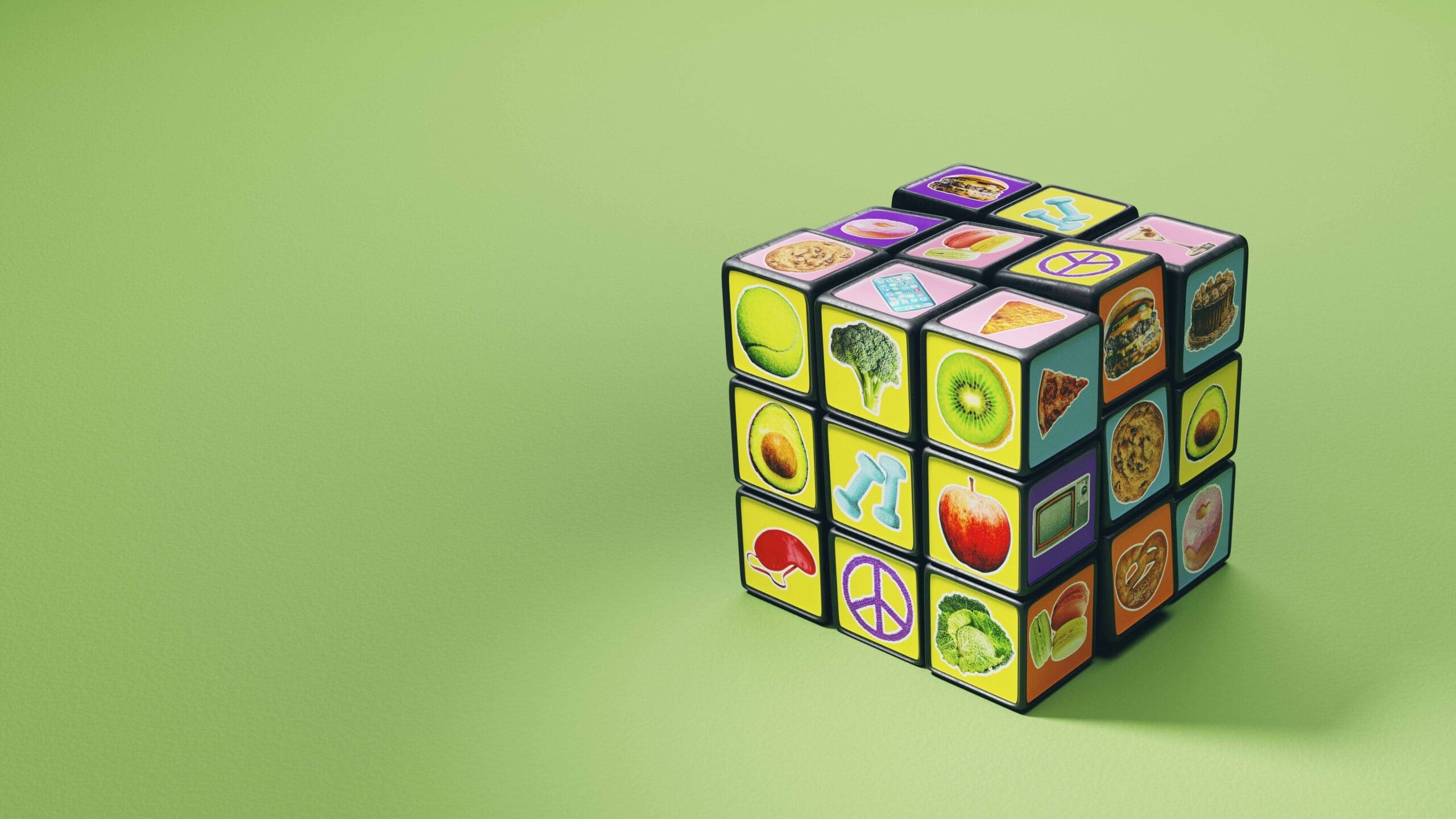 Rubick's Cube with pictures of exercise and food on a green background to illustrate how to lose weight with NEAT