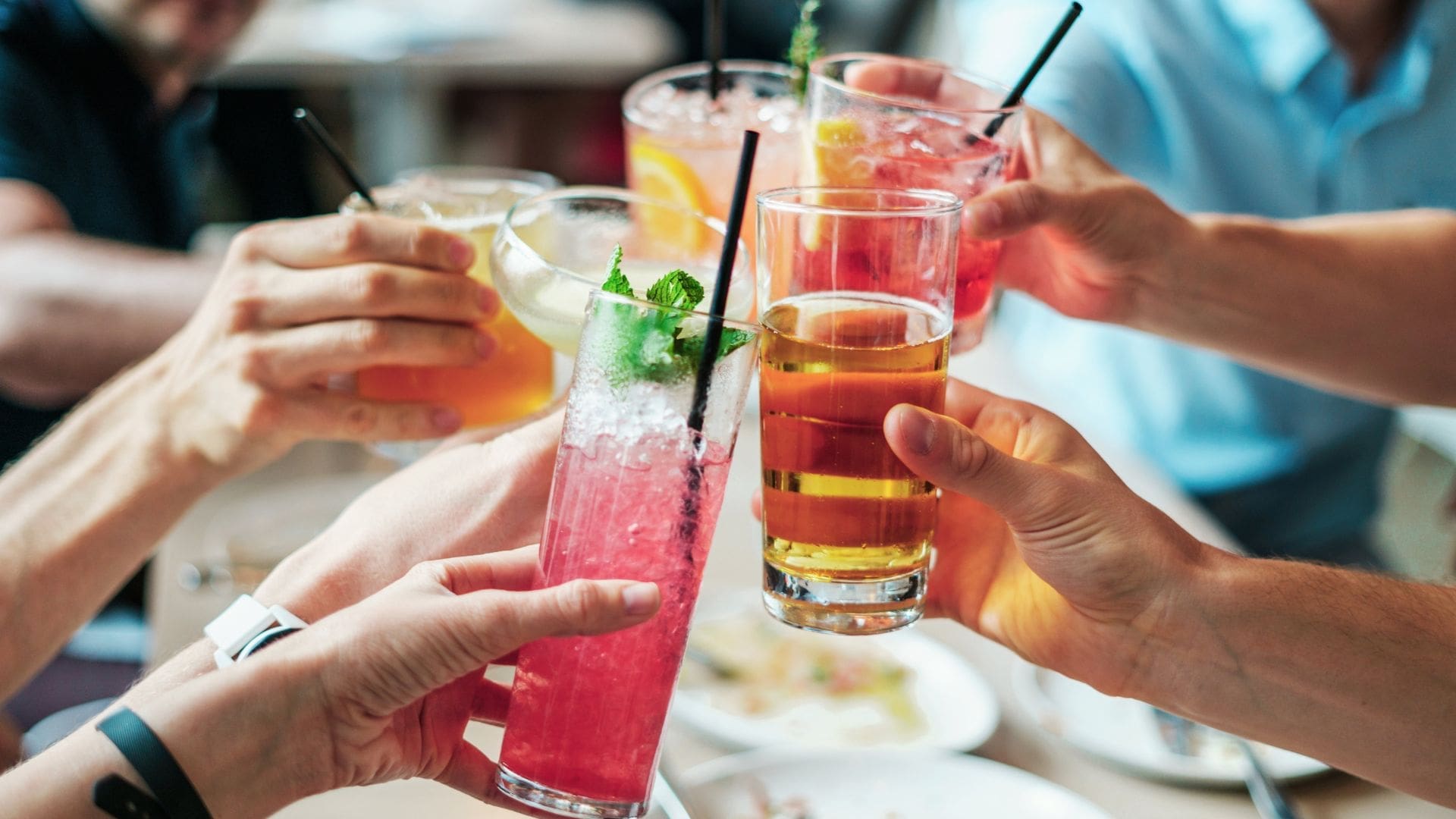 picture of social group cheersing drinks showing millennials are ditching booze for tea