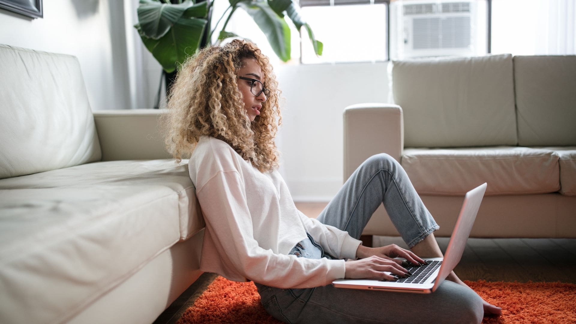 woman sitting on the floor using the computer for AI for health