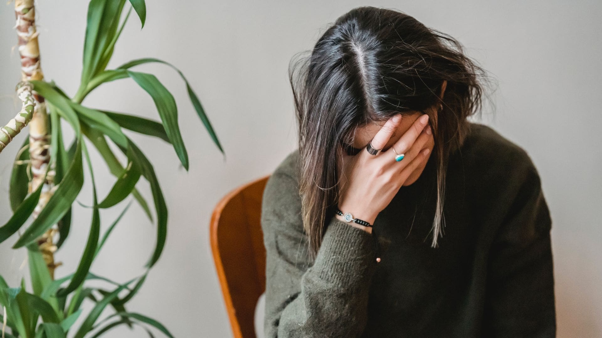 Female with head buried in hands out of frustration.