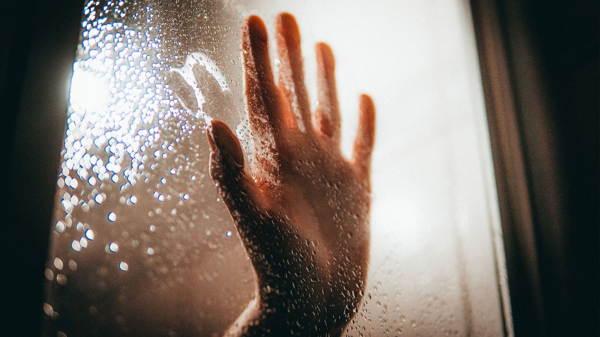 steamy hand behind shower door
