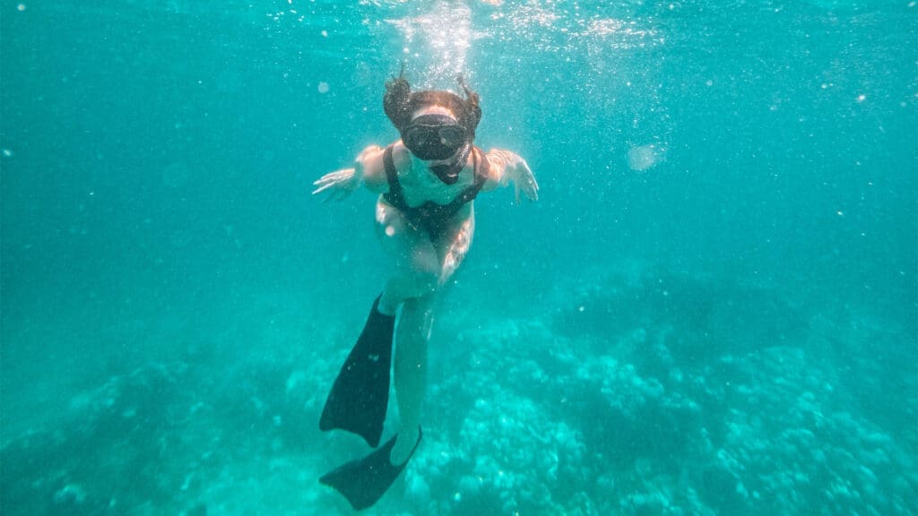 woman snorkelling in blue water