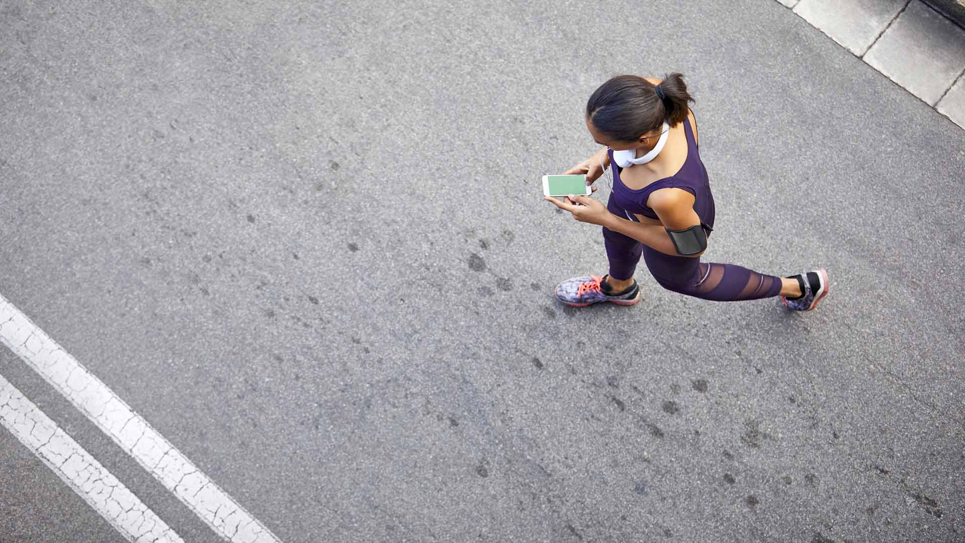Woman using mobile phone while walking on street