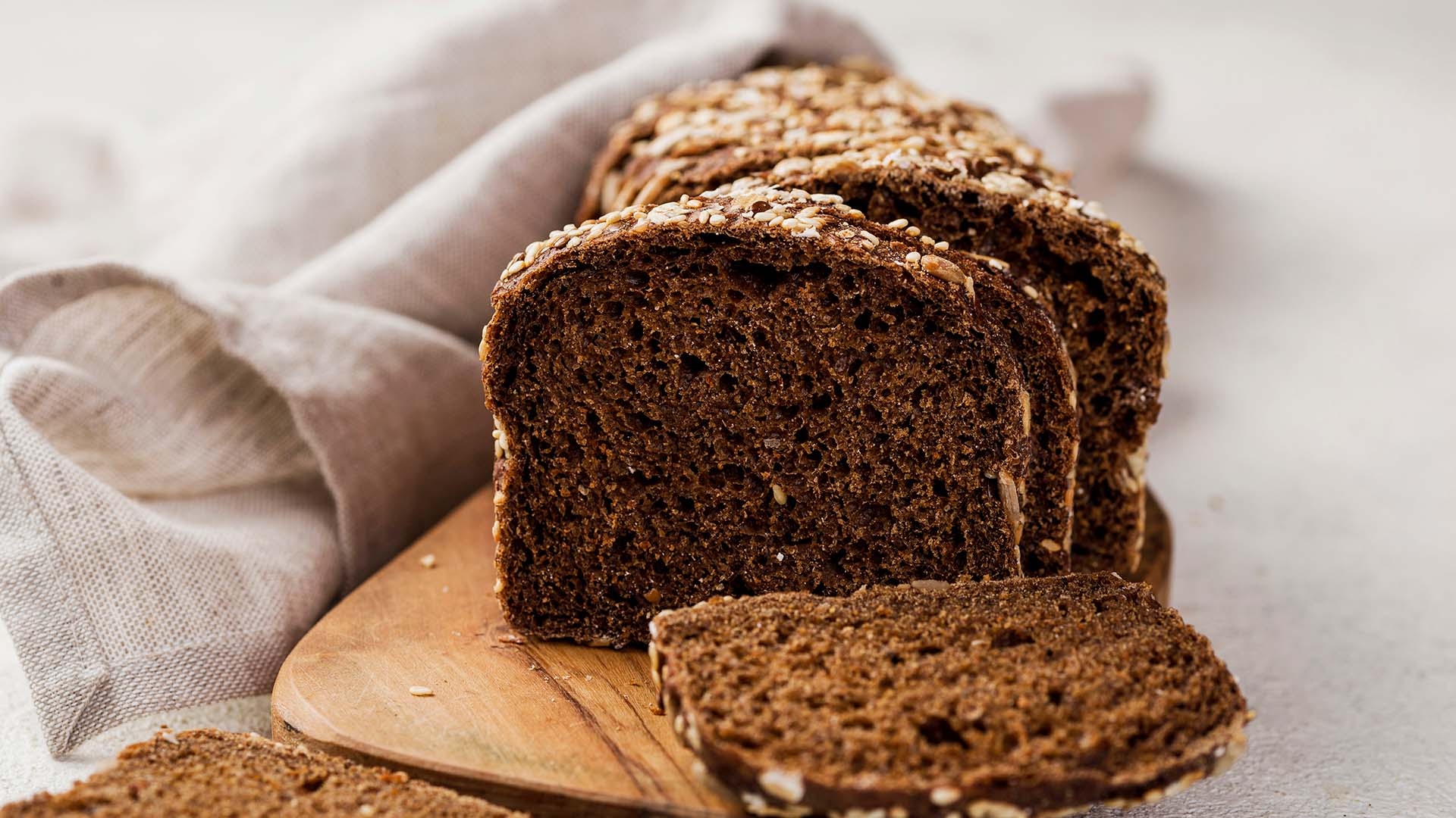 Slices of low gi bread on a wooden board